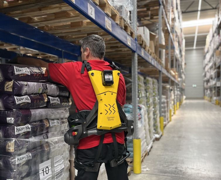 Andreas Schmid Group Employee utilizing an exoskeleton for work.